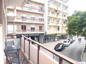 a balcony of a hotel with a sign that reads the hair shop at Casa da Baixa in Faro