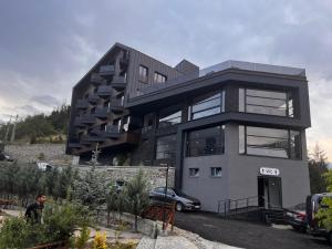 a building with a car parked in front of it at Ladur Resort Otel in Trabzon