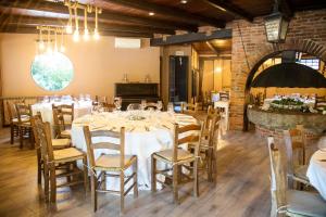a dining room with a long table and chairs at La Favola in Soriso