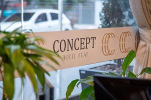 a sign in a window that reads concept hollywood hat at Concept Hotel Flat in Balneário Camboriú