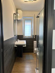 a bathroom with a sink and a window at Bella Blue B&B in Bisceglie