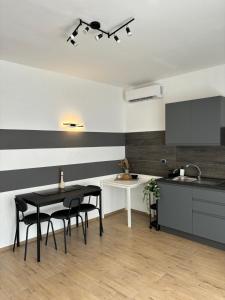 a kitchen with black and white striped walls and a table and chairs at Bella Blue B&B in Bisceglie