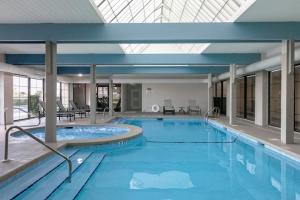 a large swimming pool in a building with a large ceiling at Bluewater Vacation Rentals in Orange Beach
