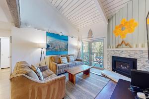 a living room with a couch and a fireplace at Chamonix 20 in Mammoth Lakes