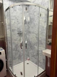 a shower with a glass enclosure in a bathroom at Paris Rooms -Rynek Centrum -F VAT in Kielce