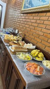 a buffet with many different types of food on a table at Pousada Casa da Vó Dita in Ouro Fino