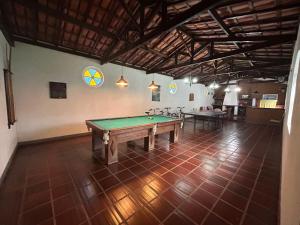 a room with a pool table in the middle of it at Pousada Casa da Vó Dita in Ouro Fino