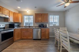 a kitchen with wooden cabinets and a table with chairs at Alpine Greens in Leavenworth