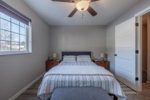 a bedroom with a bed and a ceiling fan at Alpine Greens in Leavenworth
