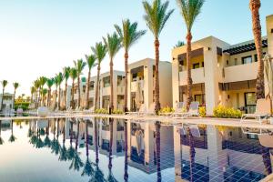 a resort with palm trees and a swimming pool at Sentido Reef Oasis Aqua Park Resort in Sharm El Sheikh