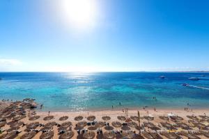 an overhead view of a beach with umbrellas and the ocean at Sentido Reef Oasis Aqua Park Resort in Sharm El Sheikh