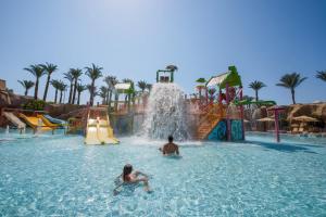 two people playing in the water at a water park at Reef Oasis Beach Aqua Park Resort in Sharm El Sheikh