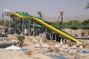 a water park with a slide and a water slide at Reef Oasis Beach Aqua Park Resort in Sharm El Sheikh