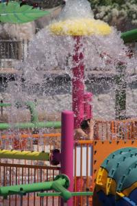 a water park with a water slide with an umbrella at Reef Oasis Beach Aqua Park Resort in Sharm El Sheikh