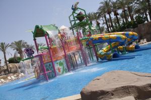 a water park with a water slide in a pool at Reef Oasis Beach Aqua Park Resort in Sharm El Sheikh