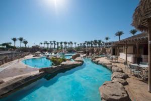 a pool at a resort with blue water at Reef Oasis Beach Aqua Park Resort in Sharm El Sheikh