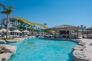 a pool at a water park with a roller coaster at Reef Oasis Beach Aqua Park Resort in Sharm El Sheikh