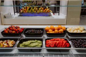 a display of fruits and vegetables in trays on a counter at Reef Oasis Beach Aqua Park Resort in Sharm El Sheikh