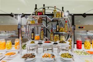 a buffet with bowls of food on a table at Reef Oasis Beach Aqua Park Resort in Sharm El Sheikh