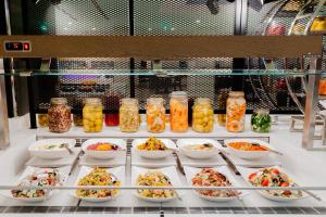 a buffet filled with bowls of food on a table at Reef Oasis Beach Aqua Park Resort in Sharm El Sheikh