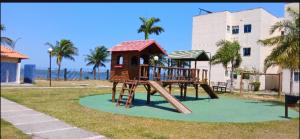 a playground with a slide and a play structure at Sua casa na praia em Cabo Frio in São Pedro da Aldeia