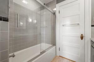a bathroom with a shower and a glass door at Luxurious Hidden Gem in Manchester