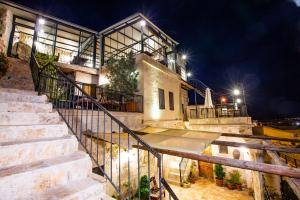 a building with stairs leading up to it at night at kayadibi cave hotel in Ürgüp