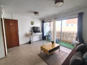a living room with a couch and a coffee table at RenTenerife Tropical Banana El Medano in El Médano +11 photos