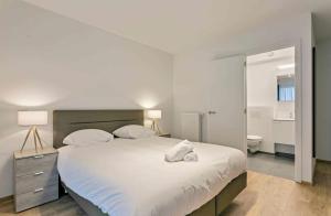 a bedroom with a large bed and a bathroom at Two Bedroom Apartment with Amazing View in Center in Brussels