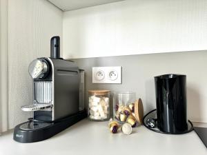 a kitchen counter with a coffee maker on a counter at Le City, Centre-ville, Climatisation, Trams in Grenoble