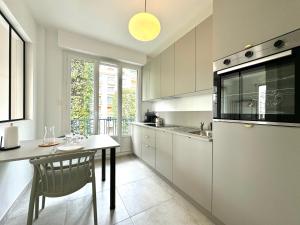 a kitchen with a table and a dining room at Le City, Centre-ville, Climatisation, Trams in Grenoble