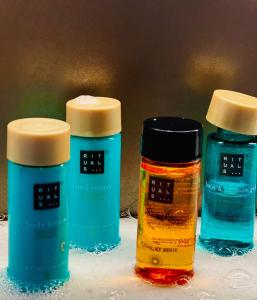 three bottles of essential oils sitting on a table at Mamma Mia Hotel Boutique - Only Adults in Tossa de Mar