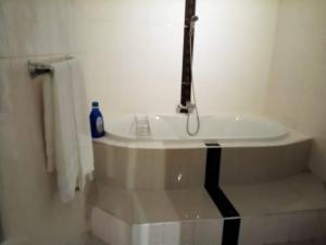 a bathroom with a sink with a faucet at Kimi's Place Lodge in Mzuzu +14 photos