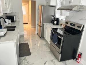 a kitchen with a stove and a refrigerator at Treasure Haven Near Tourism Barrie in Barrie +8 photos