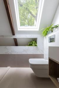 a bathroom with a toilet and a window at The Loft in Faygate