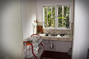 a kitchen with a sink and a window at Hansa Villa in Unawatuna +58 photos
