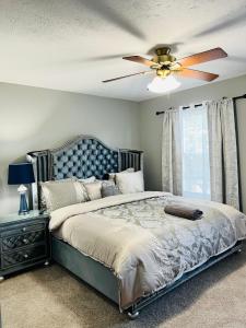 a bedroom with a bed with a ceiling fan at Find your home away from home in our delightful 4 bedroom space in Indianapolis