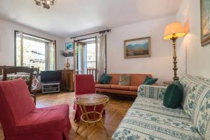 a living room with a couch and two chairs at Cozy apartment in Courmeyeur city center in Courmayeur