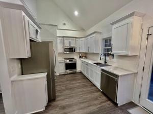 a kitchen with white cabinets and a stainless steel refrigerator at Lake Lanier House 2 in Gainesville