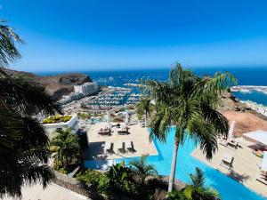 an aerial view of a resort with a pool and the ocean at Grand Horizon Luxury Boutique Apartments in Puerto Rico de Gran Canaria