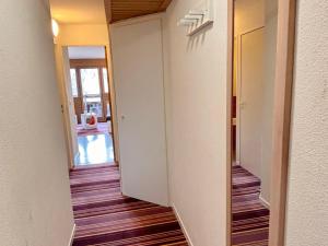 an empty hallway with a door leading into a room at Agréable 2 pièces avec balcon, internet, ménage et linge inclus - FR-1-634-102 in Morzine
