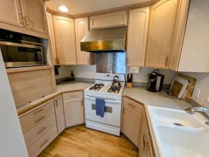 a kitchen with a white stove and a sink at Lake Front Retreat on Flathead in Bigfork