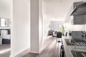 a white apartment with a kitchen and a bedroom at Stylish 2 Bed Apartment in Waterloo Liverpool in Liverpool