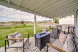 a porch with chairs and a table with a view at Seven Bays Vacation Rental on Lake Roosevelt! in Seven Bays