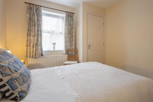 a bedroom with a bed and a window and a chair at Host & Stay - No 12 in Alnwick