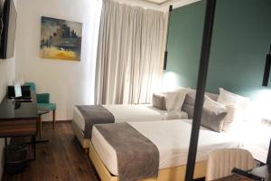 Voodi või voodid majutusasutuse NJ Hotel Rabat toas