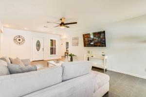 a living room with a couch and a ceiling fan at Luxury Poolside 4BR Sanctuary, Sleeps 8 in Conyers