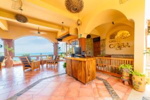 a large room with a kitchen with a view of the ocean at Casa Ceiba Huatulco - Adults Only in Santa Cruz Huatulco