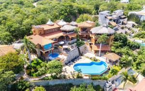 an aerial view of a house with a swimming pool at Casa Ceiba Huatulco - Adults Only in Santa Cruz Huatulco