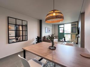 a dining room with a wooden table and chairs at Parallelo loft Salento P5 in Salento